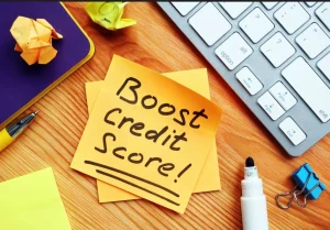 a sticky note reading boos credit score next to a keyboard